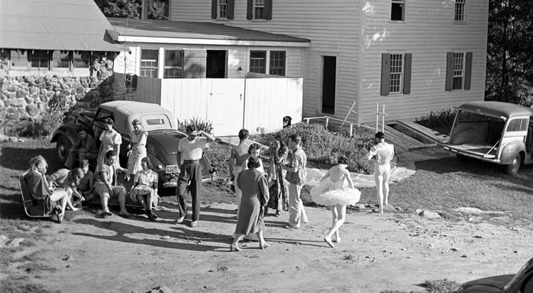 Dancers gathered outside the Stone Dining room; the original farmhouse ,now known as Hunter House, can be seen to the right. Photo by Hans Knopf, 1941.